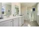 Well-lit bathroom featuring a double vanity, a glass-enclosed shower, and stylish finishes at 1447 Nokota Dr., Conway, SC 29526