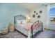 Stylish bedroom with a metal frame bed, flower wall decor, and coordinated decorative accents at 1447 Nokota Dr., Conway, SC 29526