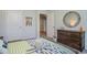 Bedroom showcasing a rope-framed round mirror, wooden dresser, and coastal-themed decorations at 1447 Nokota Dr., Conway, SC 29526
