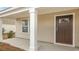 Inviting covered front porch with white pillars and a dark brown front door at 1447 Nokota Dr., Conway, SC 29526