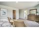 Comfortable primary bedroom with two chairs and view of the ensuite bathroom and walk-in closet at 1447 Nokota Dr., Conway, SC 29526