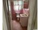 Retro bathroom with pink tile, a classic vanity, and a matching toilet at 1504 Chester St., Myrtle Beach, SC 29577