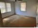 This bedroom offers natural light through its windows and has worn flooring at 1504 Chester St., Myrtle Beach, SC 29577