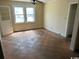 Spacious living room featuring large windows and worn checkerboard floors at 1504 Chester St., Myrtle Beach, SC 29577