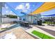 Entertainer's backyard with a dining table, lounge chairs, BBQ grill, and cornhole at 1512 S Ocean Blvd., North Myrtle Beach, SC 29582