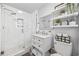 Stylish bathroom featuring a walk-in shower with marble tile, a vanity, and decorative shelves at 1512 S Ocean Blvd., North Myrtle Beach, SC 29582
