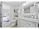 Well-lit bathroom featuring a marble vanity, toilet, and connecting bedroom at 1512 S Ocean Blvd., North Myrtle Beach, SC 29582