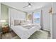 Well-lit bedroom featuring a queen bed, a large window, and a woven rug at 1512 S Ocean Blvd., North Myrtle Beach, SC 29582