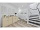 Bright entryway with decorative wall art, stylish cabinets and a staircase leading to the upper level at 1512 S Ocean Blvd., North Myrtle Beach, SC 29582
