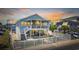 Charming two-story beach home with a white picket fence and spacious covered porch, perfect for coastal living and entertaining at 1512 S Ocean Blvd., North Myrtle Beach, SC 29582