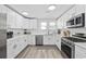 Well-lit kitchen featuring stainless steel appliances, white cabinetry, granite countertops, and modern fixtures at 1512 S Ocean Blvd., North Myrtle Beach, SC 29582