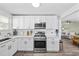 Bright kitchen featuring stainless steel appliances, granite countertops, white cabinets, and modern fixtures at 1512 S Ocean Blvd., North Myrtle Beach, SC 29582