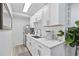 Modern kitchenette with white cabinets, stainless steel appliances, and a stylish sink with countertop at 1512 S Ocean Blvd., North Myrtle Beach, SC 29582