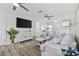 Cozy living room with ceiling fans, comfortable seating, a stylish rug, and a large flat-screen TV for entertainment at 1512 S Ocean Blvd., North Myrtle Beach, SC 29582