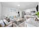 Bright living room with a comfortable sofa, modern chairs, and an open view to the kitchen area at 1512 S Ocean Blvd., North Myrtle Beach, SC 29582
