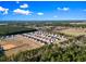 Sprawling community aerial view with a park and baseball field surrounded by wooded area at 154 Seasons Trace Loop, Longs, SC 29568