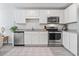 Bright kitchen boasts stainless steel appliances, white cabinets, granite countertops, and decorative floor covering at 154 Seasons Trace Loop, Longs, SC 29568