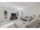 Bright living room with modern gray sofas, wood entertainment center, and a door to the outdoor space at 154 Seasons Trace Loop, Longs, SC 29568