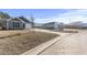 Street view of well-maintained homes featuring a neatly landscaped yard and driveway at 154 Seasons Trace Loop, Longs, SC 29568