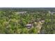 This aerial view features a cozy home nestled among lush, dense trees and greenery at 1651 Weldon Ln., Conway, SC 29526