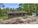 Charming cabin-style home featuring a cozy front porch and rustic wood siding surrounded by lush greenery at 1651 Weldon Ln., Conway, SC 29526