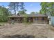 View of home featuring a rustic wood exterior, front porch, and a spacious yard surrounded by mature trees at 1651 Weldon Ln., Conway, SC 29526