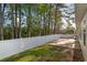 Backyard featuring a white vinyl fence, green grass, and a concrete patio at 180 Oak Crest Circle, Longs, SC 29568
