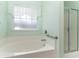 Relaxing bathroom featuring a large tub with shower and a glass-enclosed shower stall at 180 Oak Crest Circle, Longs, SC 29568