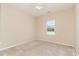 Bedroom showcasing neutral walls, carpet flooring, ceiling fan and window offering natural light at 180 Oak Crest Circle, Longs, SC 29568