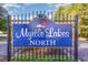Myrtle Lakes North entrance sign in an established community featuring a bright red cardinal at 180 Oak Crest Circle, Longs, SC 29568
