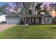 Charming single-story home featuring a well-manicured lawn, covered porch, and attached garage at 180 Oak Crest Circle, Longs, SC 29568
