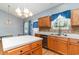 Kitchen features wood cabinets, stainless steel dishwasher, backsplash, and a center island at 180 Oak Crest Circle, Longs, SC 29568