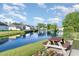 Scenic pond view with calm water, a picnic table, and lush landscaping at 180 Oak Crest Circle, Longs, SC 29568
