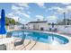 Community pool with bright blue water, lounge chairs, tables, and a pool house at 180 Oak Crest Circle, Longs, SC 29568
