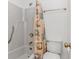 Bathroom featuring a shower and tub combination with seashell shower curtain at 1801 N Ocean Blvd. # A4, North Myrtle Beach, SC 29582
