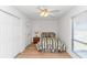 Bedroom with white walls, wood-look floors, and a ceiling fan at 1801 N Ocean Blvd. # A4, North Myrtle Beach, SC 29582