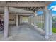 Spacious carport area with concrete flooring, wooden support beams, and a glimpse of the water view at 1801 N Ocean Blvd. # A4, North Myrtle Beach, SC 29582
