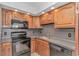 Functional kitchen with black appliances, wood cabinets, and ample counter space for meal preparation at 1801 N Ocean Blvd. # A4, North Myrtle Beach, SC 29582