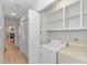 Convenient laundry room with washer, dryer, and shelving for organized storage of household essentials at 1801 N Ocean Blvd. # A4, North Myrtle Beach, SC 29582