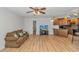 Open living room with wood floors, ceiling fan and ample natural light flowing into the kitchen at 1801 N Ocean Blvd. # A4, North Myrtle Beach, SC 29582