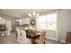 Dining room with a traditional table, chandelier, window views, and an open kitchen in the background at 1804 Hardwood Ct., Conway, SC 29526
