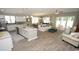 Open-concept living space featuring a kitchen with island, dining area, and comfortable seating at 1804 Hardwood Ct., Conway, SC 29526