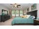 Relaxing main bedroom with ceiling fan, natural light from the windows, and elegant decor at 1804 Hardwood Ct., Conway, SC 29526
