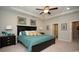Cozy main bedroom with ceiling fan, palm tree wall art, and comfortable furnishings at 1804 Hardwood Ct., Conway, SC 29526