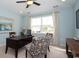 Bright office space with a desk, two patterned chairs, and a window letting in natural light at 1804 Hardwood Ct., Conway, SC 29526