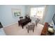Bright office space with a desk, two patterned chairs, and a window letting in natural light at 1804 Hardwood Ct., Conway, SC 29526