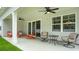 Covered porch with outdoor seating and ceiling fans, perfect for relaxing at 1804 Hardwood Ct., Conway, SC 29526