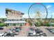 Aerial view of a vibrant amusement park with an upside-down building, a ferris wheel, and a crowded parking lot at 191 Maison Dr. # B-319, Myrtle Beach, SC 29572