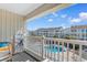 Balcony view overlooking a community pool and resort buildings on a clear day at 191 Maison Dr. # B-319, Myrtle Beach, SC 29572