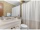 Bathroom with a cream colored vanity, toilet, and shower with a white curtain at 191 Maison Dr. # B-319, Myrtle Beach, SC 29572
